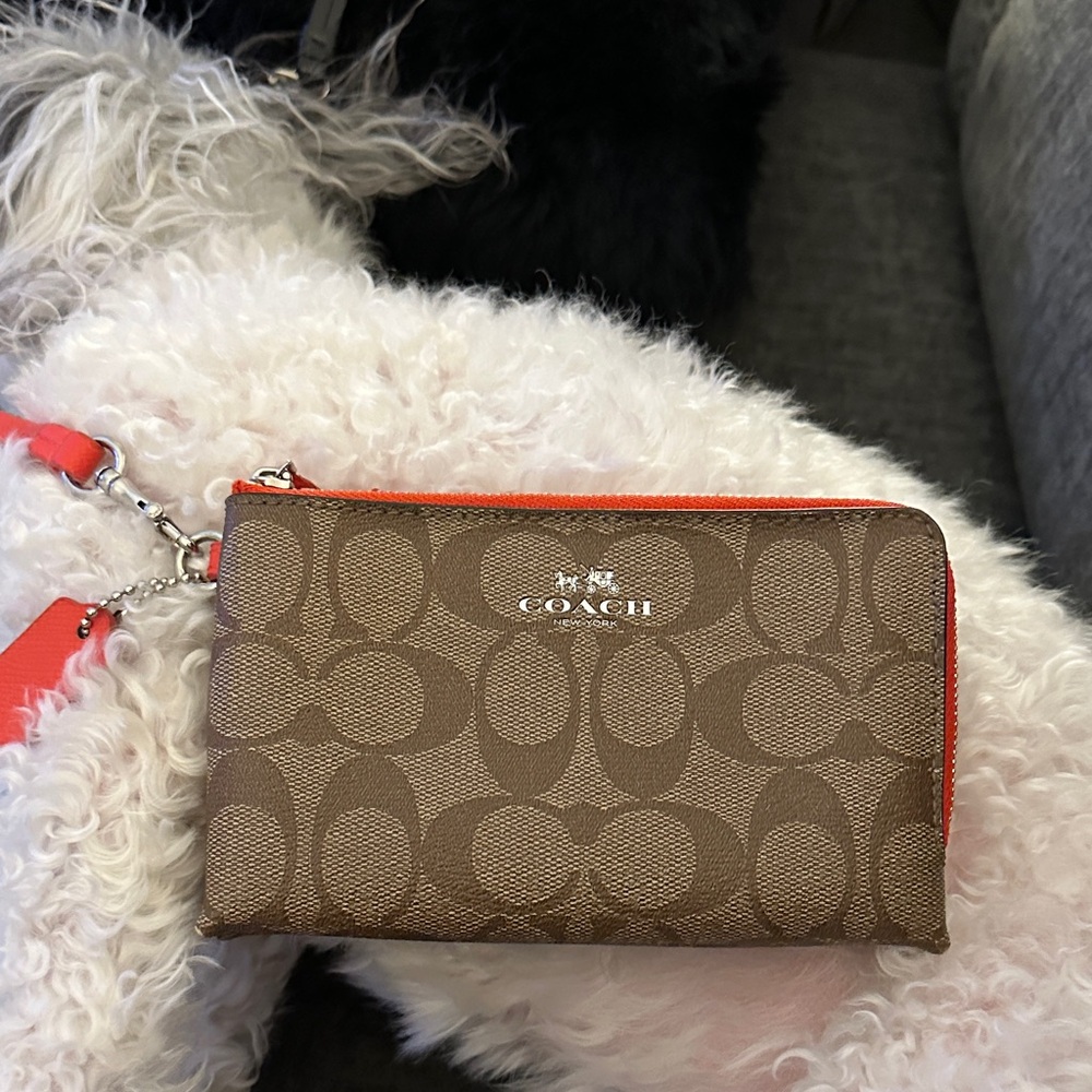 Coach double zipper Brown Wristlet with Orange Accents & has original hang tag.